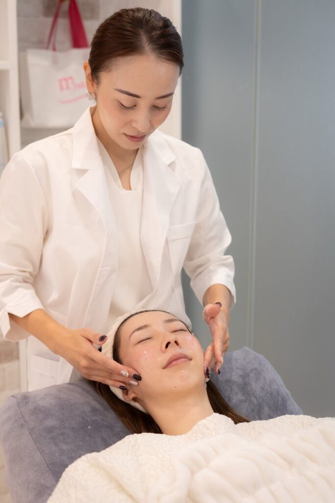 CHIO, a Japanese esthetician in Osaka, performing a facial treatment on a client.